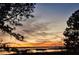 Stunning sunset over a calm lake with a dock in the foreground at 462 Sweetwater Way, Haines City, FL 33844