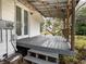 Spacious back porch with wooden deck and steps leading down at 520 S 10Th St, Lake Wales, FL 33853