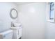 Small bathroom with white vanity and round mirror at 520 S 10Th St, Lake Wales, FL 33853