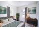 Bedroom with a cozy bed, dresser, and large windows at 520 S 10Th St, Lake Wales, FL 33853
