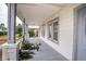 Large front porch with wooden flooring and decorative plants at 520 S 10Th St, Lake Wales, FL 33853
