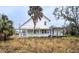 White two-story house with side yard and porch at 520 S 10Th St, Lake Wales, FL 33853
