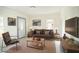Living room with brown leather furniture, coffee table, and large TV at 520 S 10Th St, Lake Wales, FL 33853