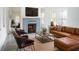 Spacious living room featuring a fireplace and leather furniture at 520 S 10Th St, Lake Wales, FL 33853