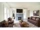 Living room with fireplace, leather sofas, and large TV at 520 S 10Th St, Lake Wales, FL 33853