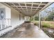Long side porch with concrete flooring and covered area at 520 S 10Th St, Lake Wales, FL 33853