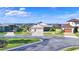 Houses with three-car garages, paved driveways, and landscaping at 537 Pond Cypress Ct, Auburndale, FL 33823