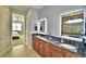 Double vanity bathroom with granite countertop and view of bedroom at 537 Pond Cypress Ct, Auburndale, FL 33823