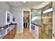 Elegant bathroom with double vanity, walk-in shower, and large closet at 537 Pond Cypress Ct, Auburndale, FL 33823