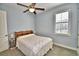 Comfortable bedroom with ceiling fan and window with shutters at 537 Pond Cypress Ct, Auburndale, FL 33823