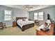Spacious bedroom with large bed, window seating, and ensuite bathroom access at 537 Pond Cypress Ct, Auburndale, FL 33823