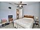 Spacious bedroom with ceiling fan, TV, and access to a bathroom at 537 Pond Cypress Ct, Auburndale, FL 33823