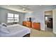 Bright bedroom with king-size bed and access to another room at 537 Pond Cypress Ct, Auburndale, FL 33823