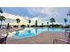 Relaxing community pool with lake views and patio furniture at 537 Pond Cypress Ct, Auburndale, FL 33823