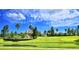 Landscaped community with pond and clubhouse at 537 Pond Cypress Ct, Auburndale, FL 33823