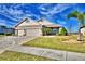 Two-story house with three-car garage and palm trees at 537 Pond Cypress Ct, Auburndale, FL 33823