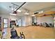Organized garage with overhead storage and epoxy flooring at 537 Pond Cypress Ct, Auburndale, FL 33823