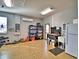 Large garage with epoxy floor, built-in shelving, and mini-fridge at 537 Pond Cypress Ct, Auburndale, FL 33823