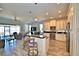 Open concept kitchen with island and stainless steel appliances at 537 Pond Cypress Ct, Auburndale, FL 33823