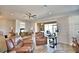 Spacious living room with leather furniture and access to a screened lanai at 537 Pond Cypress Ct, Auburndale, FL 33823