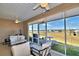 Serene screened lanai with outdoor furniture and lake view at 537 Pond Cypress Ct, Auburndale, FL 33823