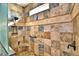 Large walk-in shower with multi-textured tile and corner seat at 537 Pond Cypress Ct, Auburndale, FL 33823