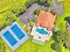 Aerial view of community amenities including tennis courts, pool, and clubhouse at 608 Sweet Bay Cir, Winter Haven, FL 33884