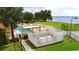Aerial view of community pool, tennis court, and lake at 608 Sweet Bay Cir, Winter Haven, FL 33884