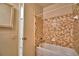 Bathroom with tub/shower combo and tan tile walls at 608 Sweet Bay Cir, Winter Haven, FL 33884