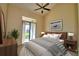 Bedroom with patio access, featuring a comfy bed and decor at 608 Sweet Bay Cir, Winter Haven, FL 33884