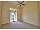 Bedroom with private balcony access and carpet flooring at 608 Sweet Bay Cir, Winter Haven, FL 33884