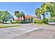 Community clubhouse with palm trees and ample parking at 608 Sweet Bay Cir, Winter Haven, FL 33884