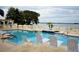 Relaxing community pool with lake views and lounge chairs at 608 Sweet Bay Cir, Winter Haven, FL 33884