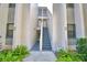 Condo building entrance with stairs and landscaping at 608 Sweet Bay Cir, Winter Haven, FL 33884
