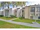 Condo building exterior with landscaping and walkway at 608 Sweet Bay Cir, Winter Haven, FL 33884