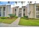 Exterior view of a condo building with landscaping and a walkway at 608 Sweet Bay Cir, Winter Haven, FL 33884