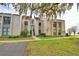 Condo building exterior showcasing landscaping and lake view at 608 Sweet Bay Cir, Winter Haven, FL 33884