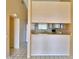 Galley kitchen with white appliances and wood cabinets at 608 Sweet Bay Cir, Winter Haven, FL 33884