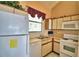 Kitchen features white appliances and wood cabinets at 608 Sweet Bay Cir, Winter Haven, FL 33884