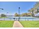 Well-maintained tennis court with lake views at 608 Sweet Bay Cir, Winter Haven, FL 33884