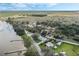 An aerial shot shows a peaceful lake, houses, and docks under a beautiful blue sky at 922 S Lake Reedy Blvd, Frostproof, FL 33843