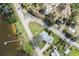 An aerial view shows the home's proximity to a body of water with a personal dock and surrounding greenery at 922 S Lake Reedy Blvd, Frostproof, FL 33843