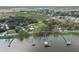 Aerial view features multiple docks and houses along a lake with a clear blue sky above at 922 S Lake Reedy Blvd, Frostproof, FL 33843