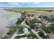 Aerial view featuring a lake with docks, homes, and roads under a clear, sunny sky at 922 S Lake Reedy Blvd, Frostproof, FL 33843
