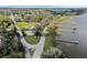 Aerial perspective showcases a lakeside community with homes, docks, and trees in a neighborhood setting at 922 S Lake Reedy Blvd, Frostproof, FL 33843