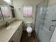 Well-lit bathroom features a vanity with sink and a stand-up shower with glass doors at 922 S Lake Reedy Blvd, Frostproof, FL 33843