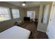 This cozy bedroom features neutral walls, wood floors, and bright natural light at 922 S Lake Reedy Blvd, Frostproof, FL 33843