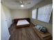 Bright bedroom featuring a ceiling fan, wood flooring, and large windows at 922 S Lake Reedy Blvd, Frostproof, FL 33843