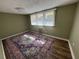 Relaxing bedroom with wood floor, big window, and large decorative rug at 922 S Lake Reedy Blvd, Frostproof, FL 33843