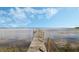 Long wooden dock extends into the tranquil water on a sunny day with a beautiful blue sky at 922 S Lake Reedy Blvd, Frostproof, FL 33843